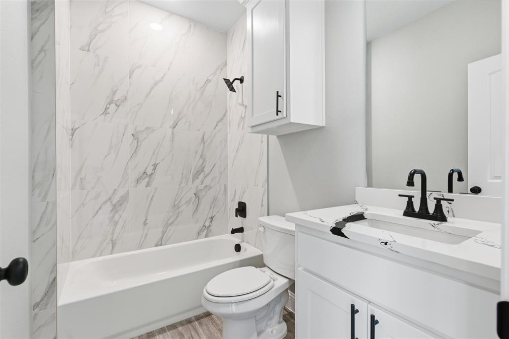 412 Ball Street Tom Bean, TX 75491 - Photo 11 of 28 a bathroom with a sink toilet and shower