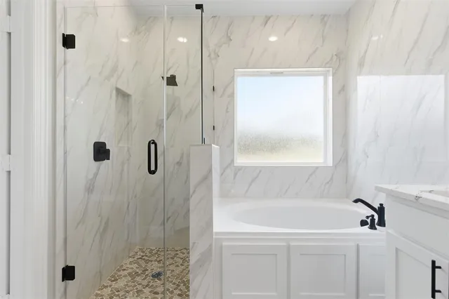 a bathroom with a bathtub and a shower