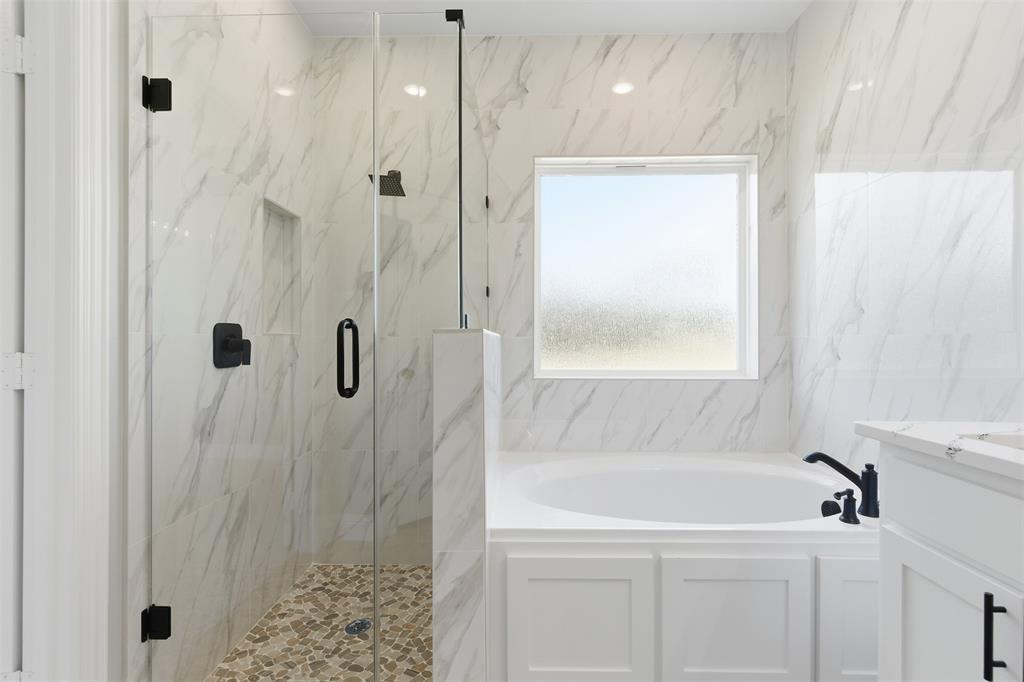 412 Ball Street Tom Bean, TX 75491 - Photo 16 of 28 a bathroom with a bathtub and a shower