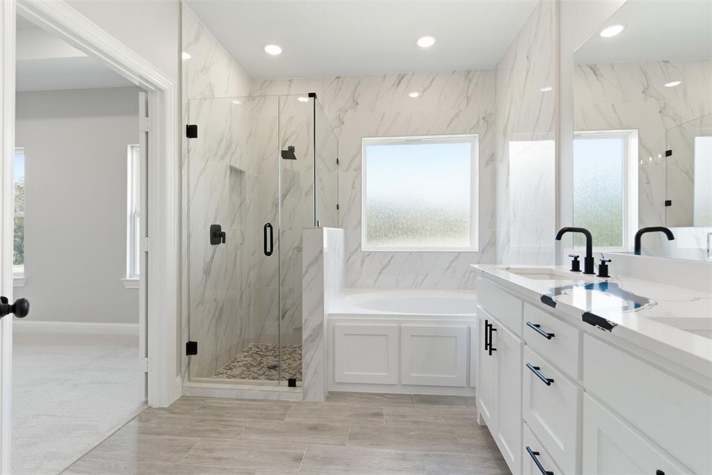412 Ball Street Tom Bean, TX 75491 - Photo 17 of 28 a bathroom with a double vanity sink a large mirror a shower and bathtub