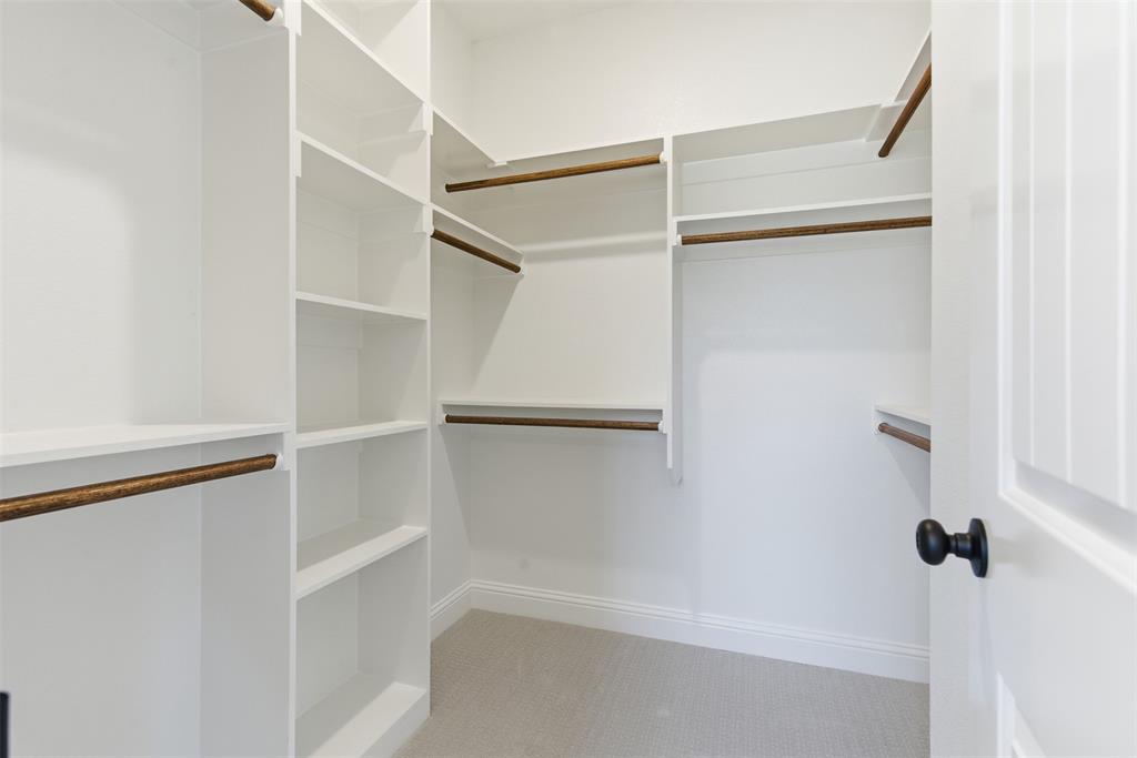 412 Ball Street Tom Bean, TX 75491 - Photo 18 of 28 a view of walk in closet with empty racks