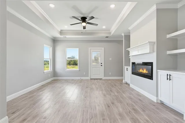 a view of an empty room with a fireplace and a window