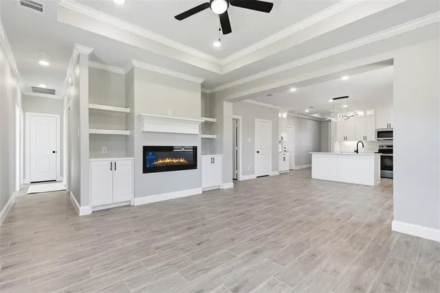a view of an empty room with a kitchen