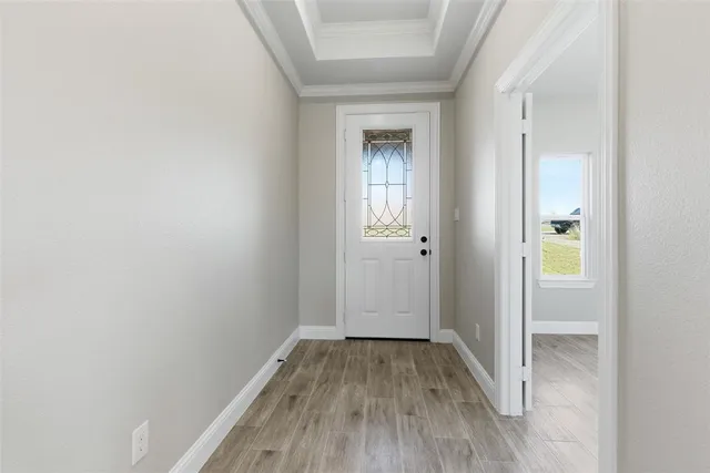 a view of a hallway with wooden floor