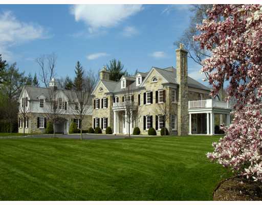 a front view of a building with a garden