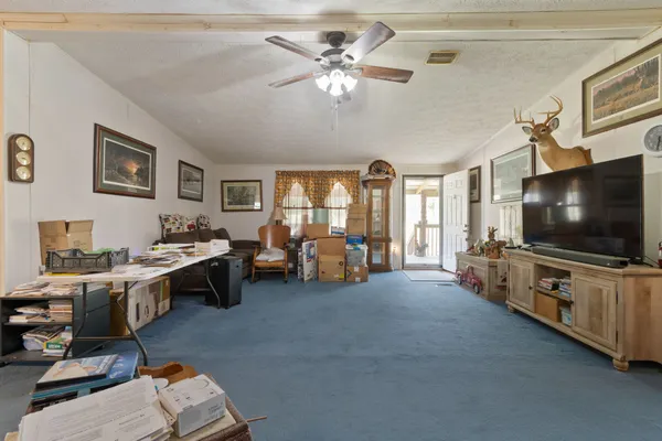 a bedroom with furniture and a large window
