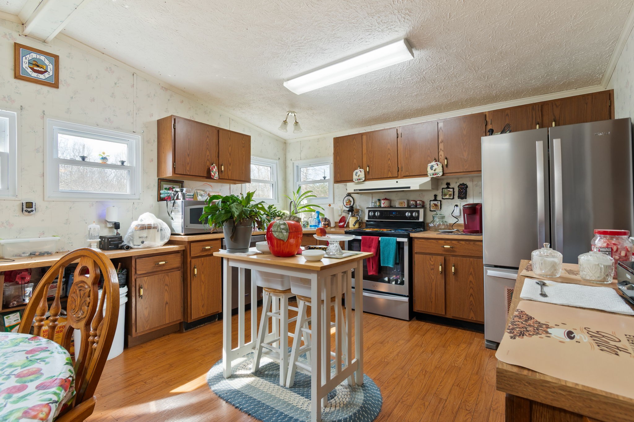 1300 New She Boss Road Duck River, TN 38454 - Photo 9 of 56 a kitchen with kitchen island a refrigerator stove and microwave