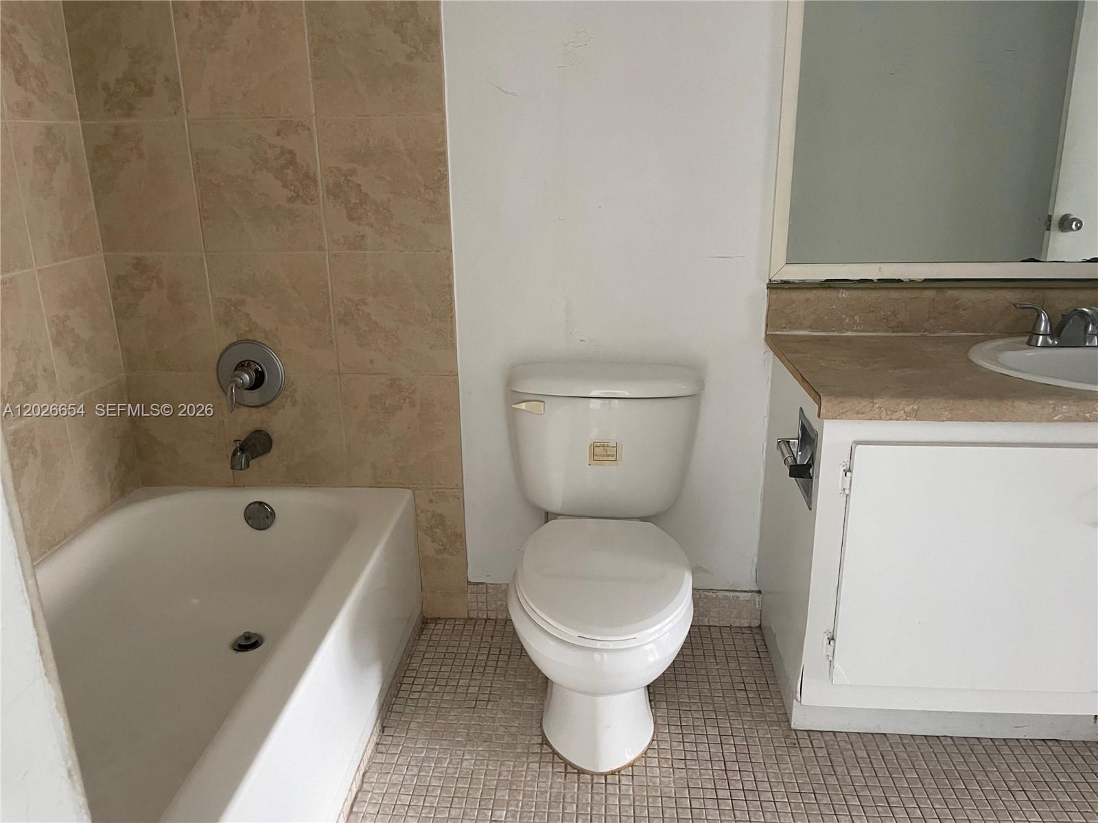 4174 Inverrary Drive, Unit 903 Lauderhill, FL 33319 - Photo 13 of 36 a bathroom with a sink a toilet and bathtub