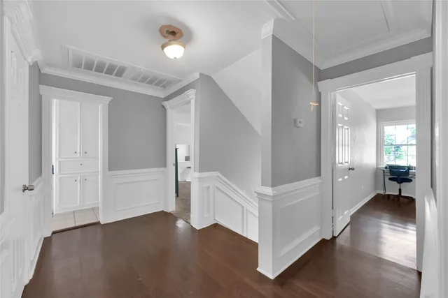 a view of an entryway with wooden floor and a livingroom