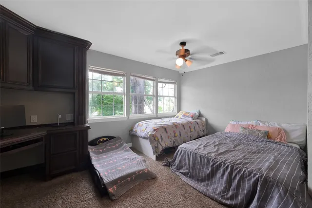 a bedroom with two beds and a window