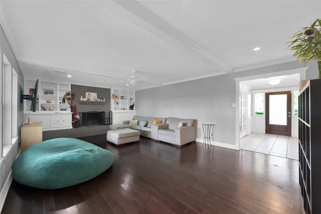 a living room with fireplace furniture and a wooden floor