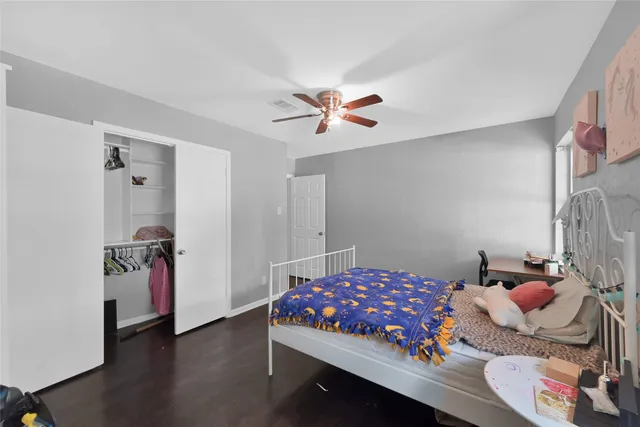 a bedroom with furniture and wooden floor