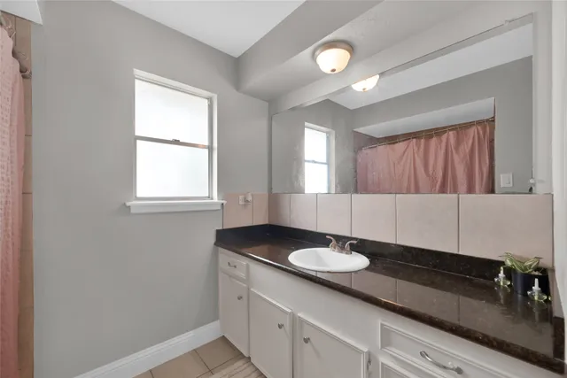 a bathroom with a sink and a mirror