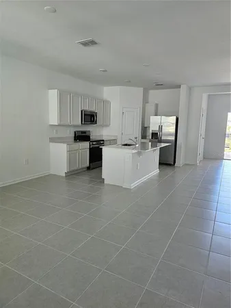 a kitchen with a sink cabinets and counter top space