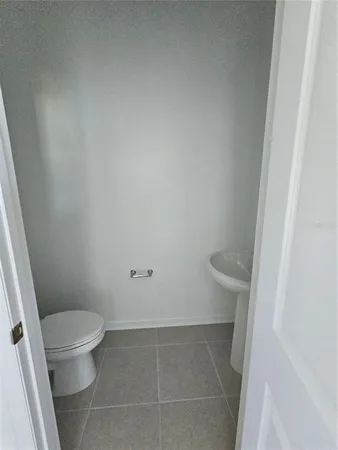 a white toilet sitting next to a white sink