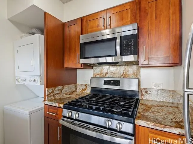 a kitchen with wooden cabinets and a stove top oven