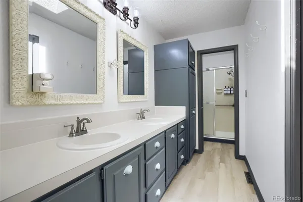 a bathroom with a double vanity sink and mirror