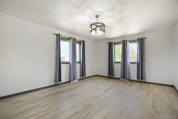 an empty room with a empty space and windows