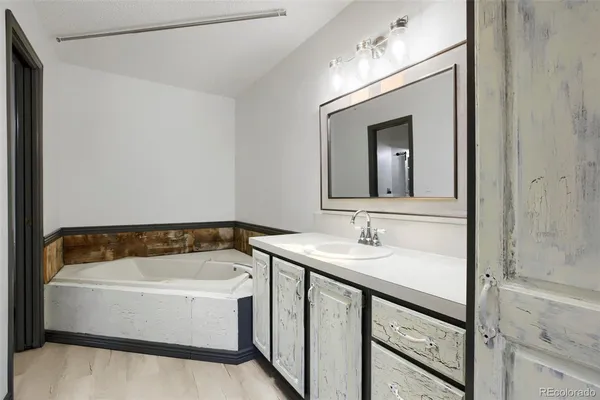 a bathroom with a bathtub and a sink