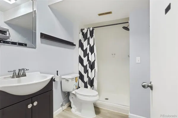 a bathroom with a sink toilet and shower