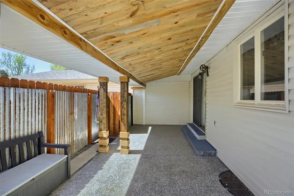 a view of a porch with wooden floor and stairs
