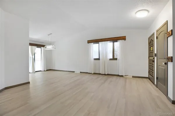 an empty room with windows and closet
