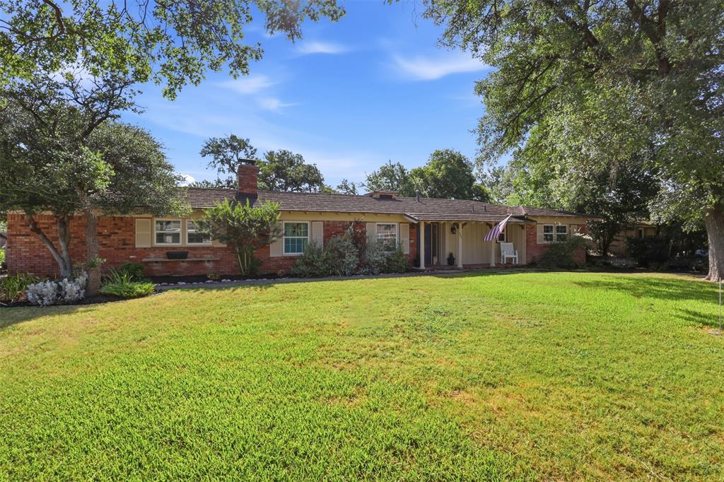 103 Paint Brush Road Lakeside, TX 76108 - Photo 3 of 24 a front view of a house with a garden and yard