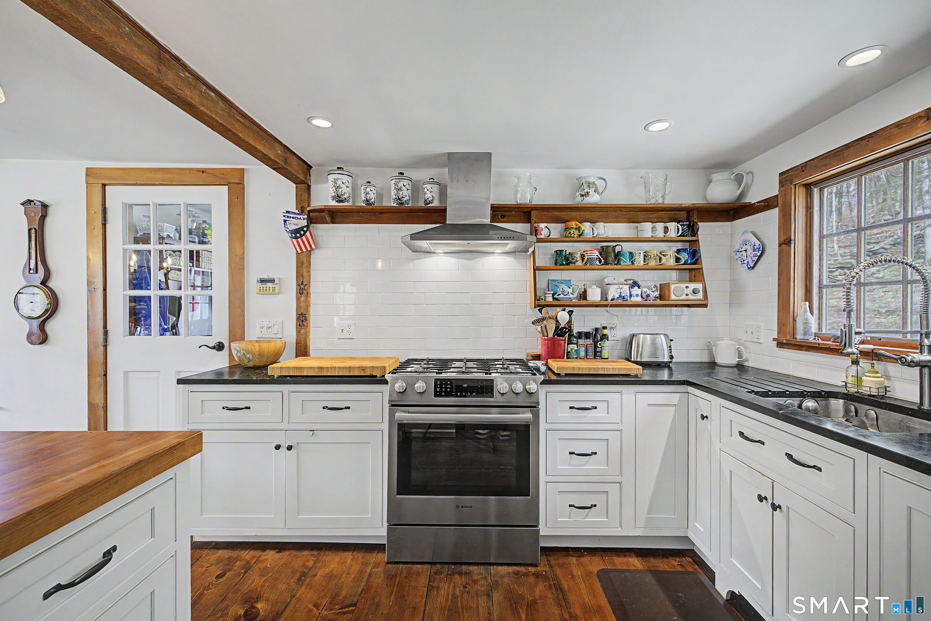 75 Lake Lillinonah Road North Bridgewater, CT 06752 - Photo 8 of 18 a kitchen with stainless steel appliances granite countertop a stove and white cabinets