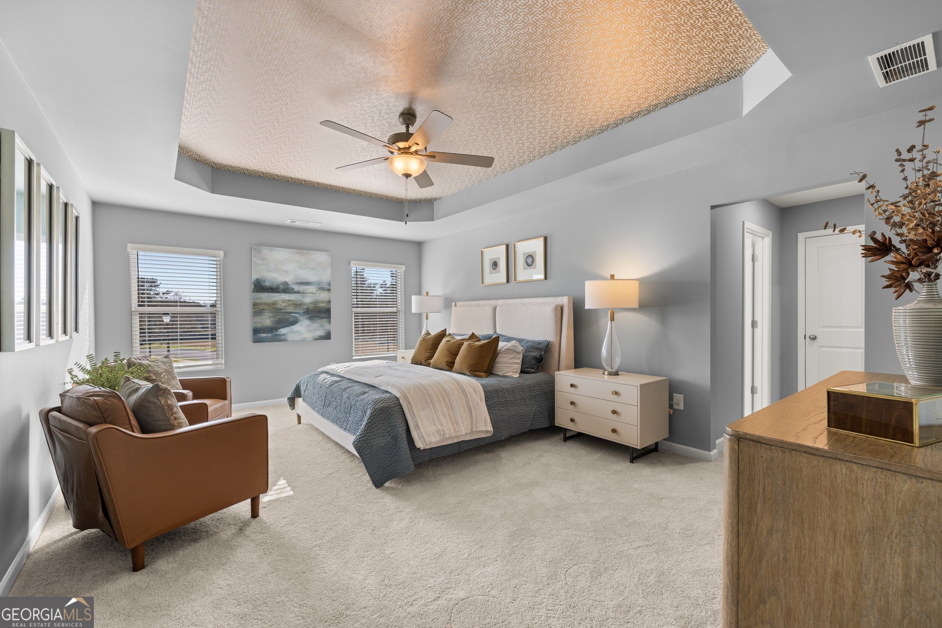 3263 Lake Carlton Road, Unit 23 Loganville, GA 30052 - Photo 22 of 33 a spacious bedroom with a bed couch and windows