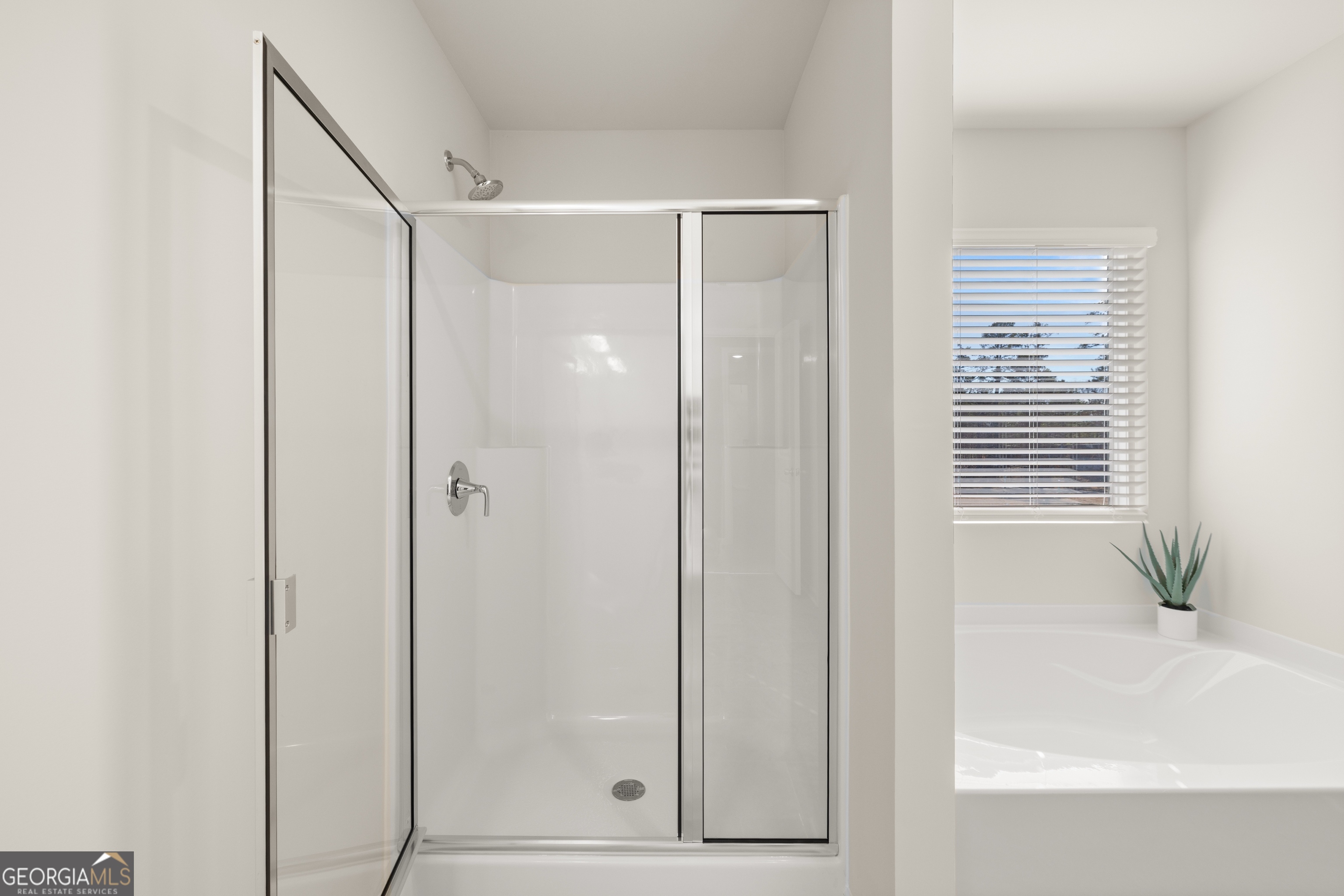 3263 Lake Carlton Road, Unit 23 Loganville, GA 30052 - Photo 27 of 33 a bathroom with a shower and a sink
