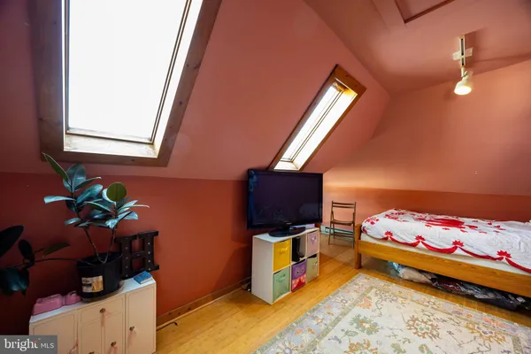 a bedroom with a bed and a tv in it