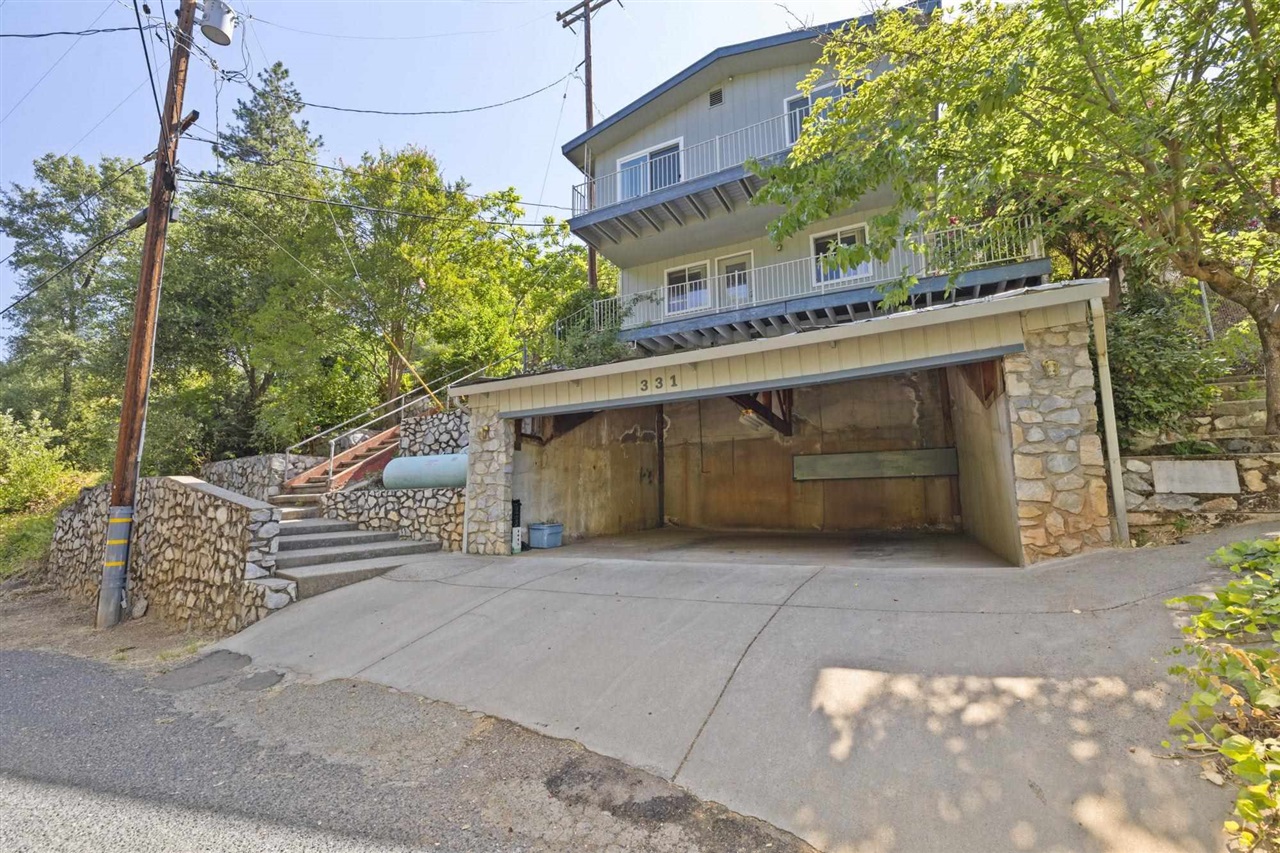 Exterior space featuring a garage and a balcony
