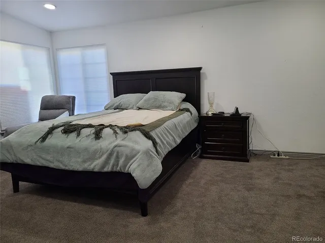 a bedroom with a bed and dresser