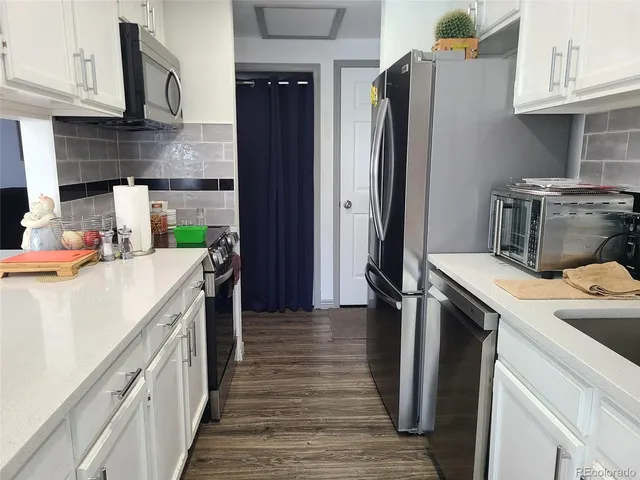 a kitchen with a sink and refrigerator