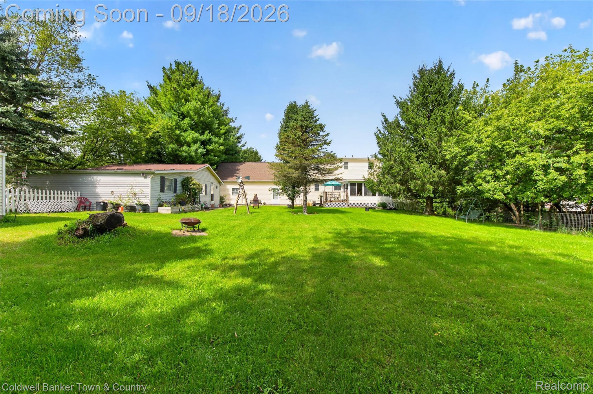 4442 McGunn Road Howell, MI 48843 - Photo 49 of 63 Expansive green lawn with mature trees and a white picket fence