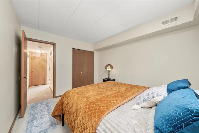 a bedroom with a bed and a closet