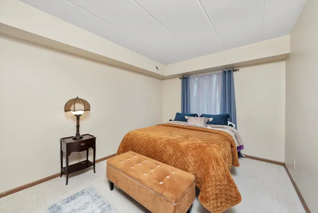 a bedroom with a bed and a mirror