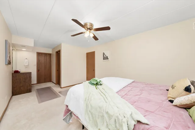 a bedroom with a bed and cabinets