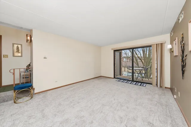 an empty room with sliding door and wooden floor