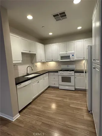 a white toilet sitting next to a bathroom sink