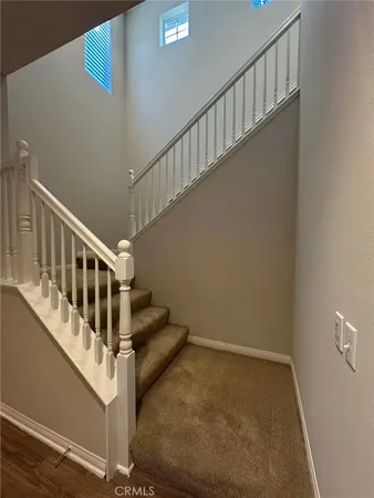 an empty room with closet and wooden door