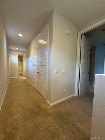 an empty room with windows and fireplace