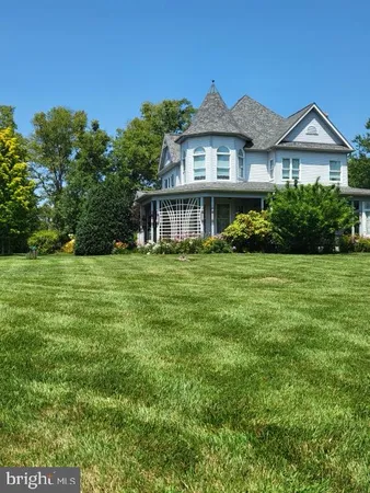 a view of a house with a big yard and potted plants