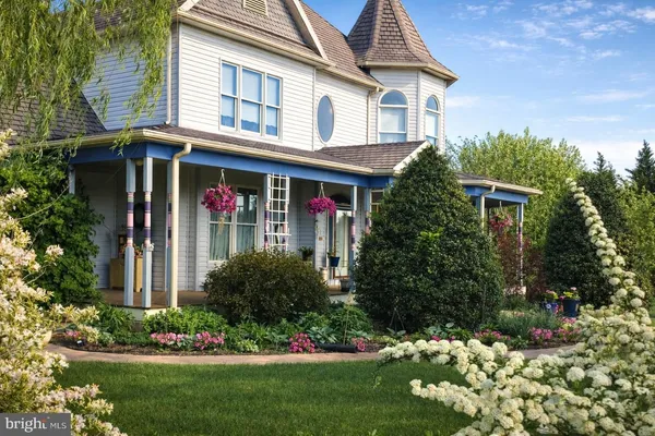 a view of a house with a yard and garden