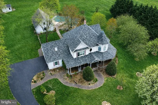 an aerial view of a house with garden space and sitting area