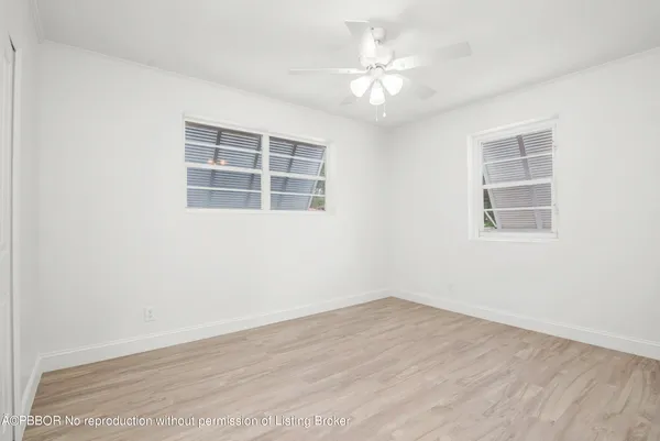 a view of a room with wooden floor and windows