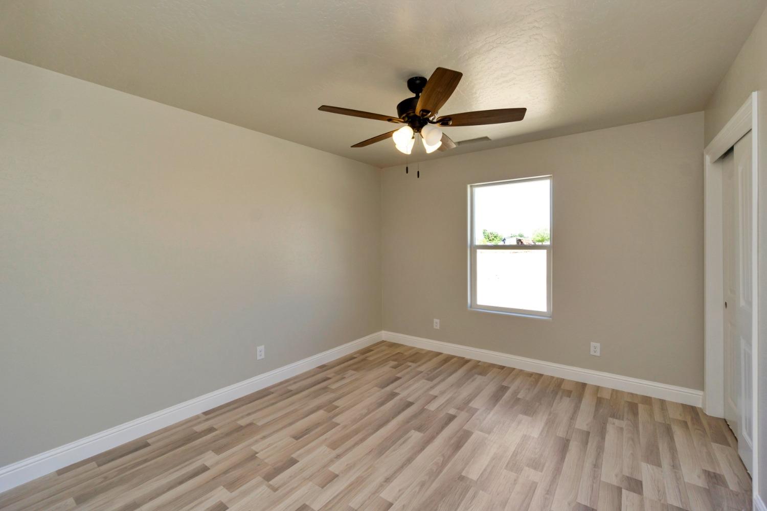 21250 Steward Road Madera, CA 93638 - Photo 13 of 40 an empty room with a window and a fan