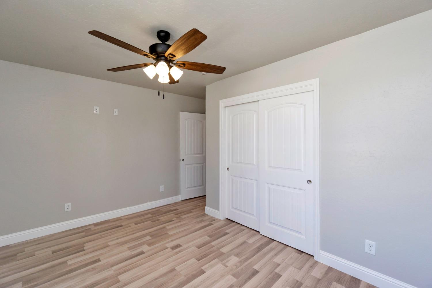 21250 Steward Road Madera, CA 93638 - Photo 16 of 40 wooden floor in an empty room with a window