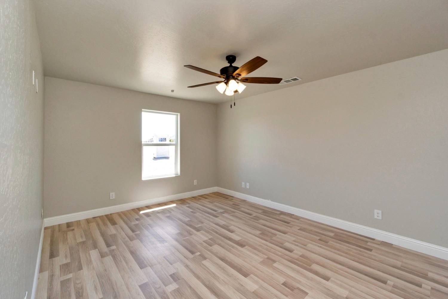 21250 Steward Road Madera, CA 93638 - Photo 18 of 40 wooden floor in an empty room with a window