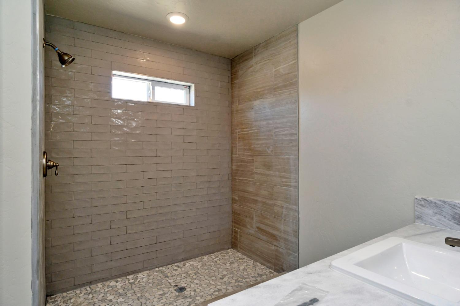 21250 Steward Road Madera, CA 93638 - Photo 21 of 40 a bathroom with a sink and a shower